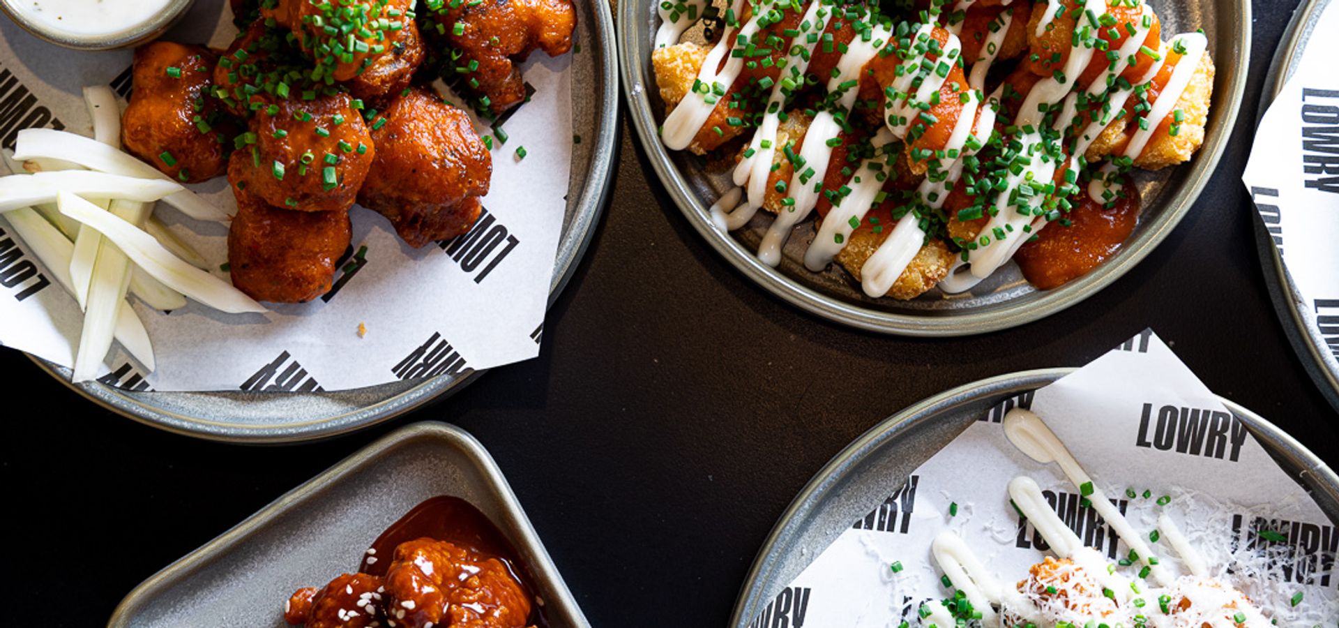 Selection of loaded fries and chicken wings served at Lowry's food and drink venues.