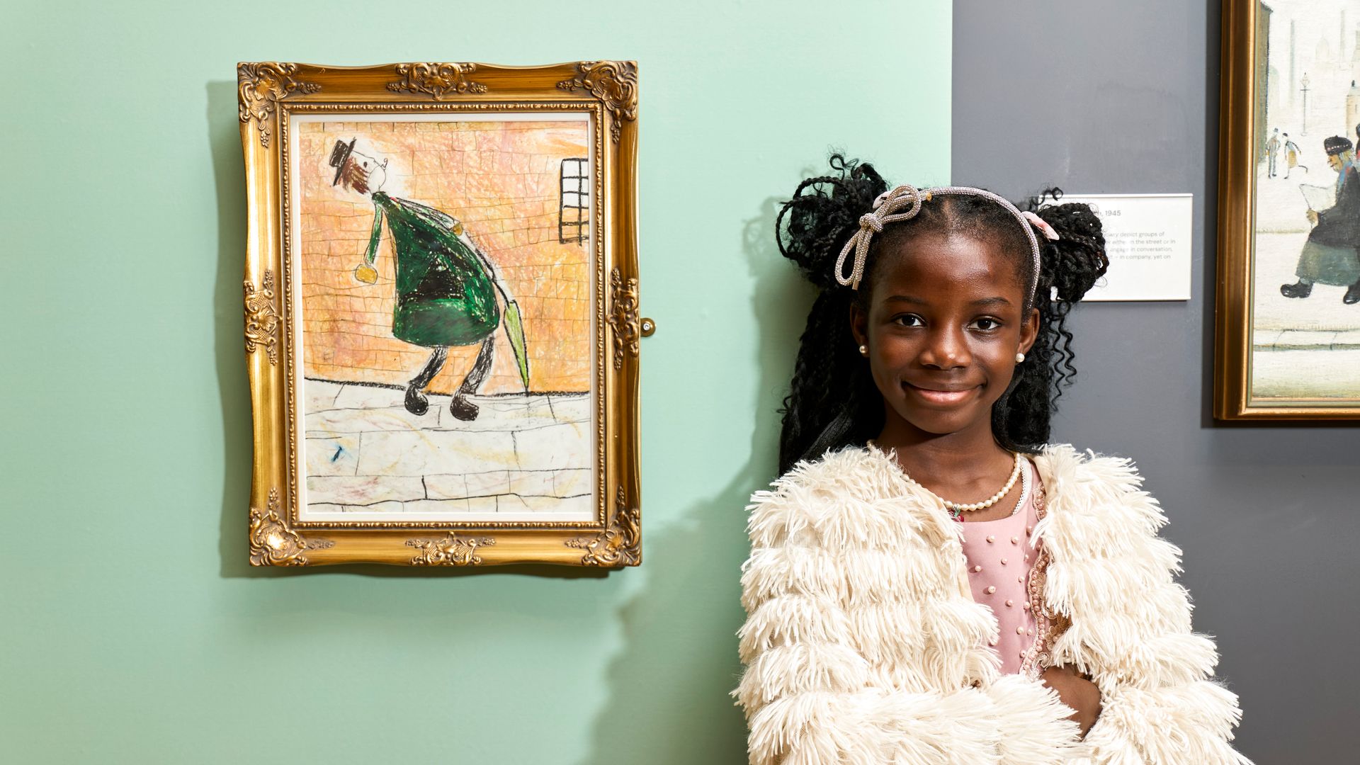 Seven-year-old Mia Ise-oluwa Asiyanbi alongside her award-winning artwork.