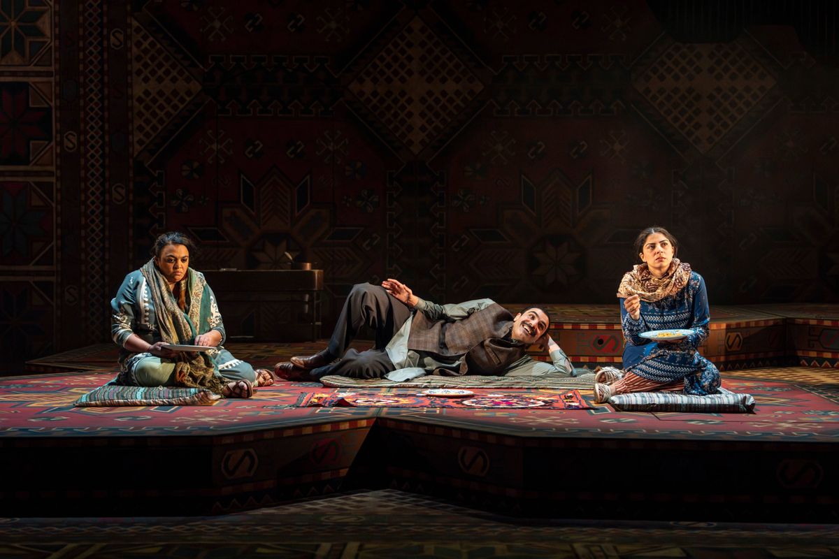Mariam, Rashed and Laila, are seated on colourful rugs, all in traditional Afgahni attire. The mood is tense, as Rasheed stares joyously at Laila while the two women look forlorn.
