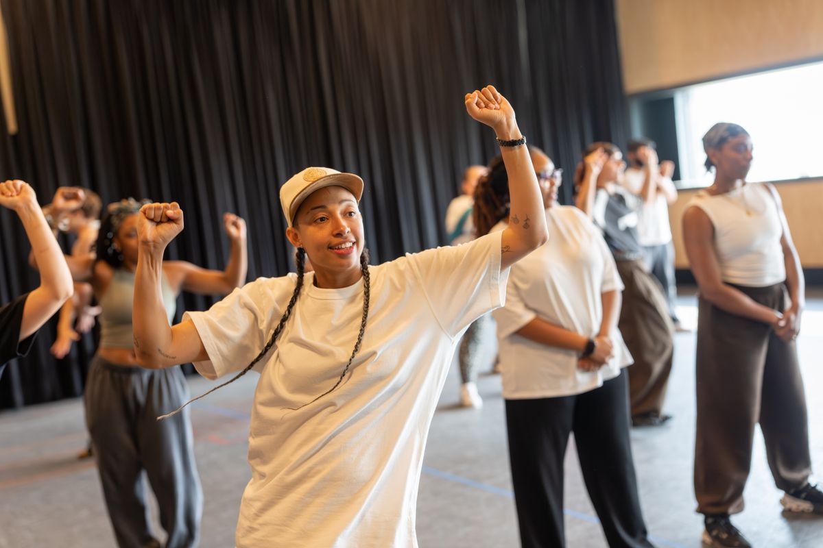 Ebony Clarke (Emily Davison/Daisy Parsons) and cast in rehearsals for Sylvia: A Musical Revolution.